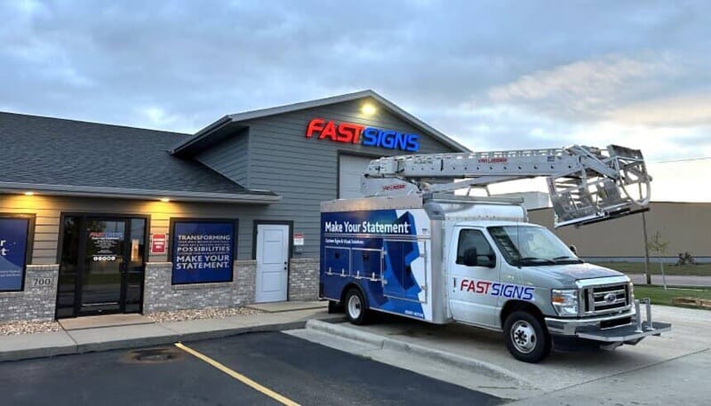 An image of the new van ladder truck with FASTSIGNS logo.